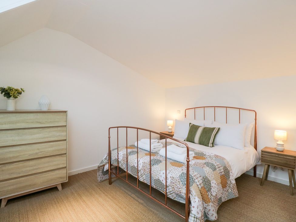 A bedroom with a bed and dresser at 3 The Stoneyard Bath