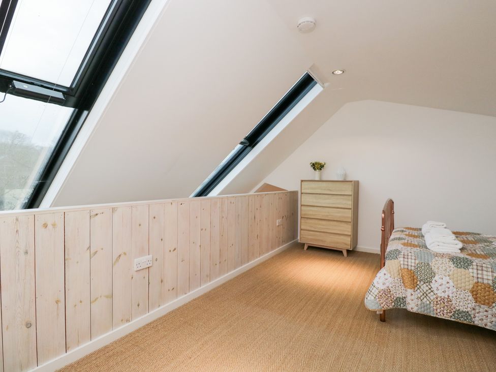 A bedroom with a bed and a dresser at 3 The Stoneyard Bath