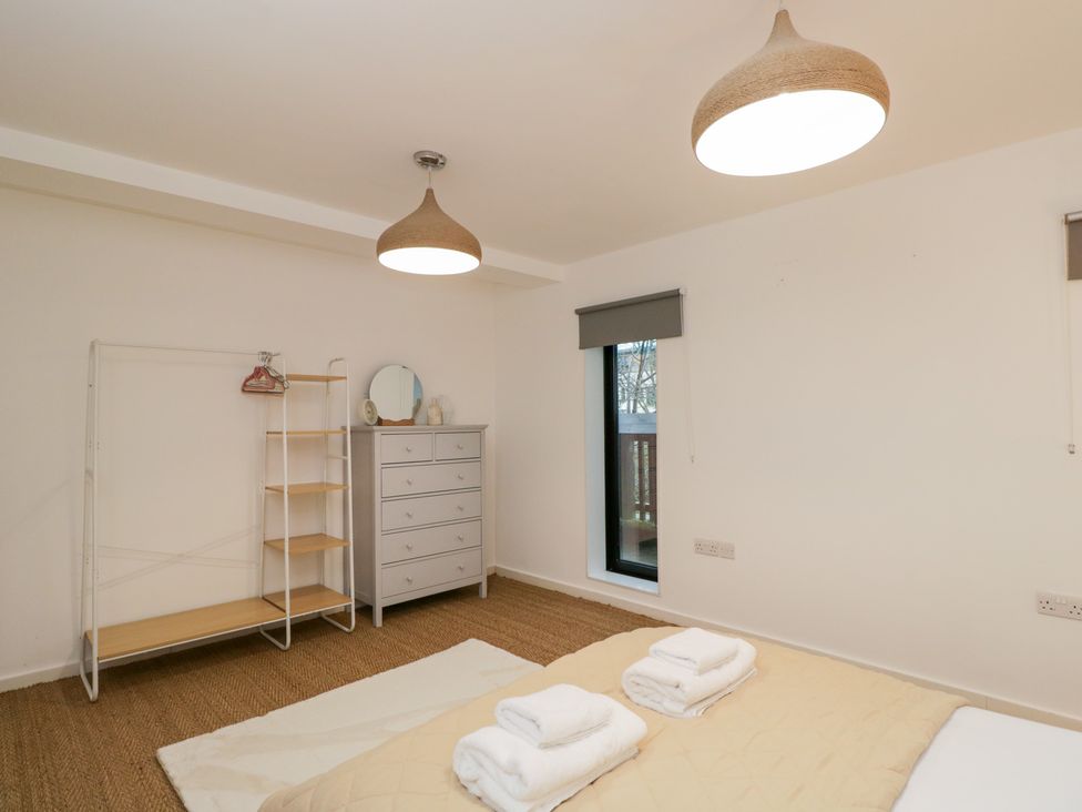 A bedroom with a bed and dresser at 3 The Stoneyard Bath
