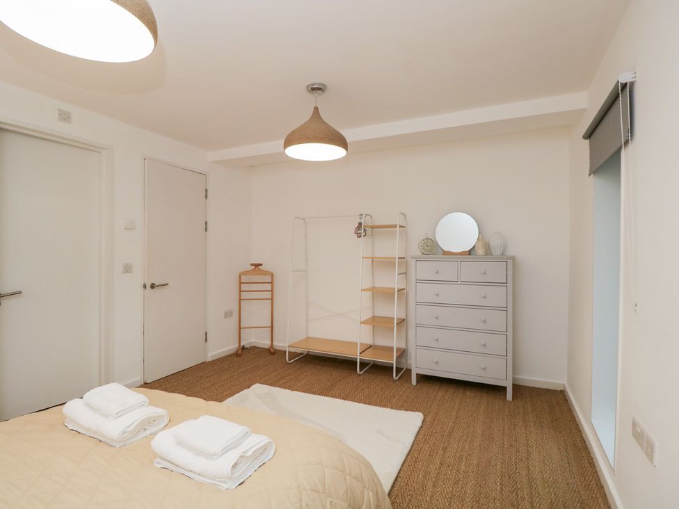 A bedroom with a bed and towels on it at 3 The Stoneyard in Bath