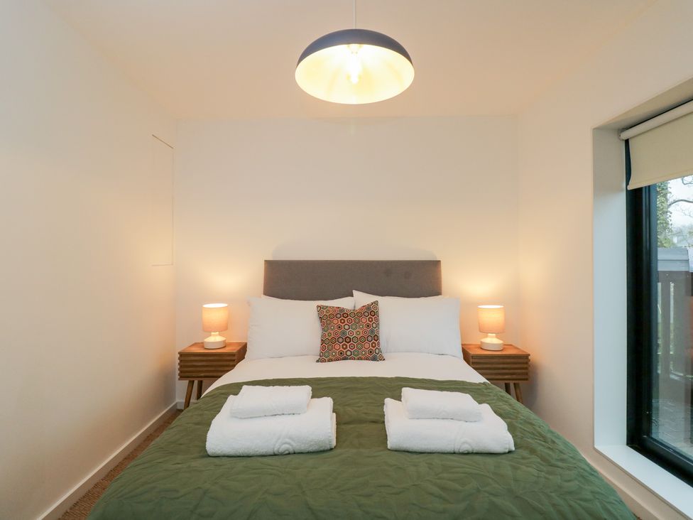 A bedroom with a bed and bedside table at 3 The Stoneyard Bath