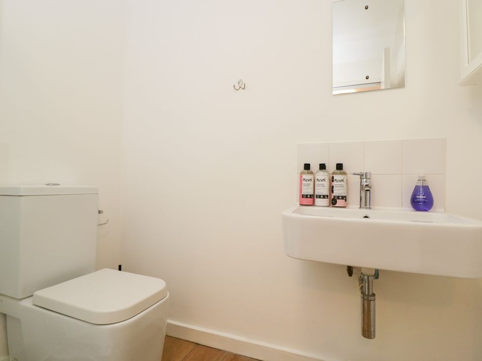 A bathroom with a toilet and sink at 3 The Stoneyard in Bath