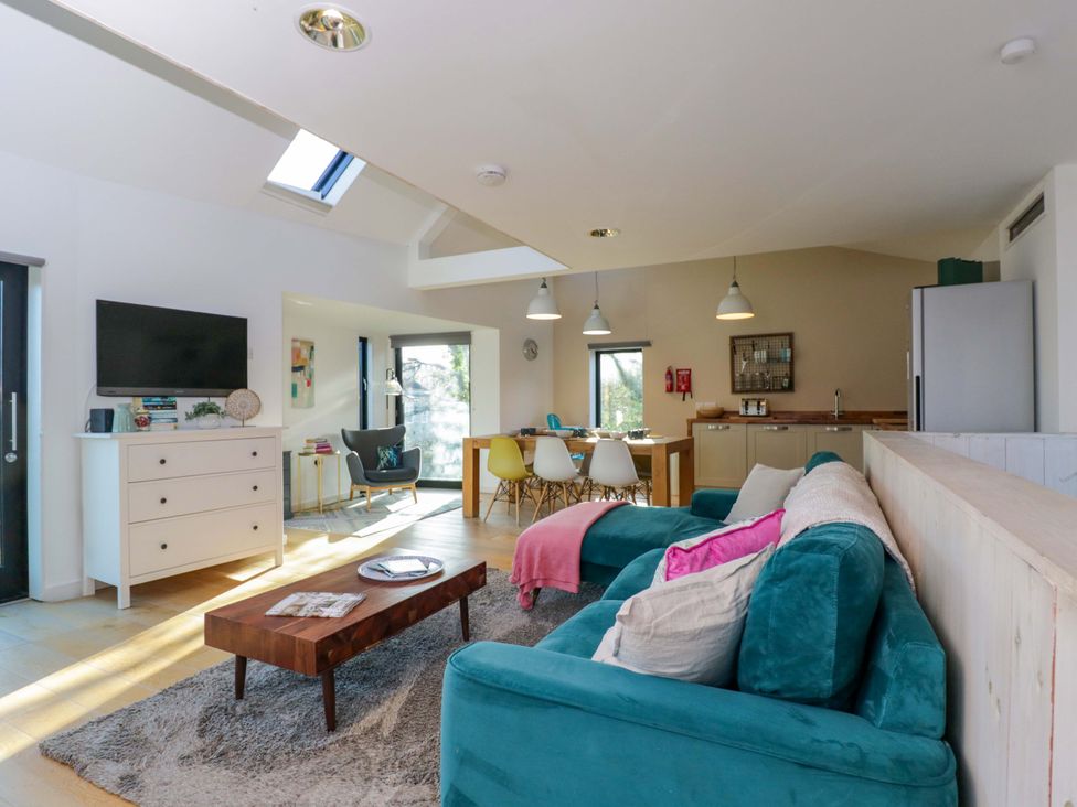 A living room with a sofa and coffee table at 4 The Stoneyard in Bath