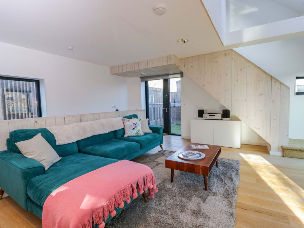 A living room with a sofa and a coffee table at 4 The Stoneyard Bath