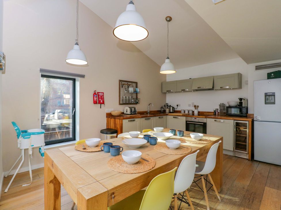 A kitchen with a dining table and chairs at 4 The Stoneyard Bath