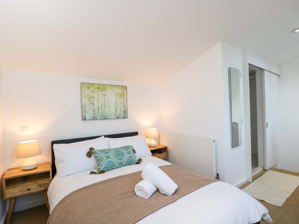 A bedroom with a bed and nightstands at 4 The Stoneyard in Bath