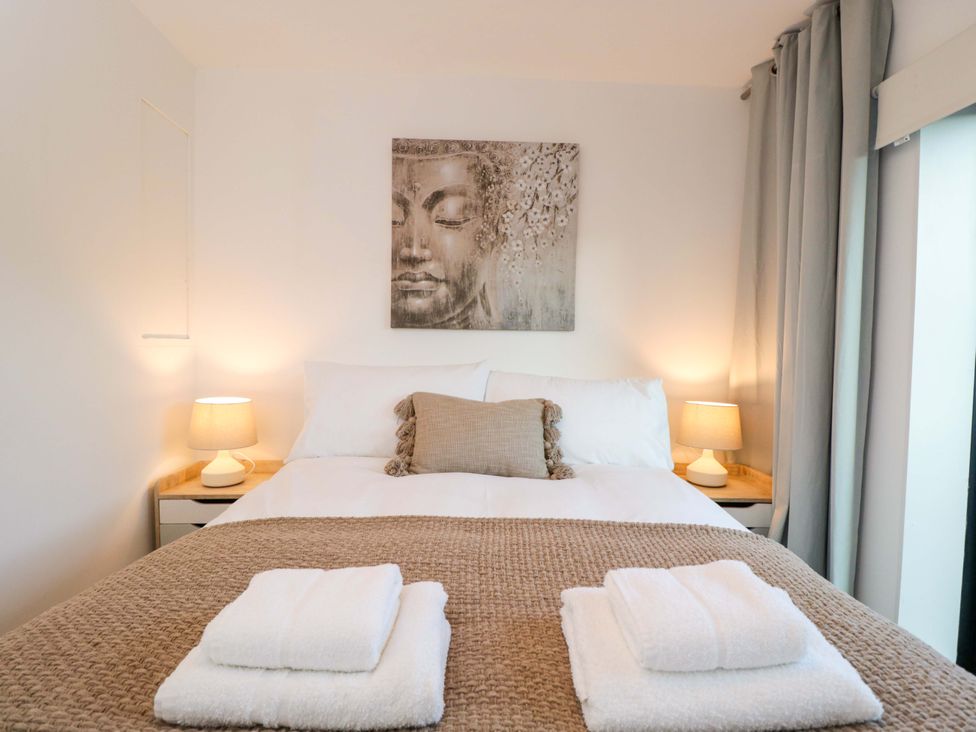 A bedroom with a bed and artwork at 4 The Stoneyard Bath