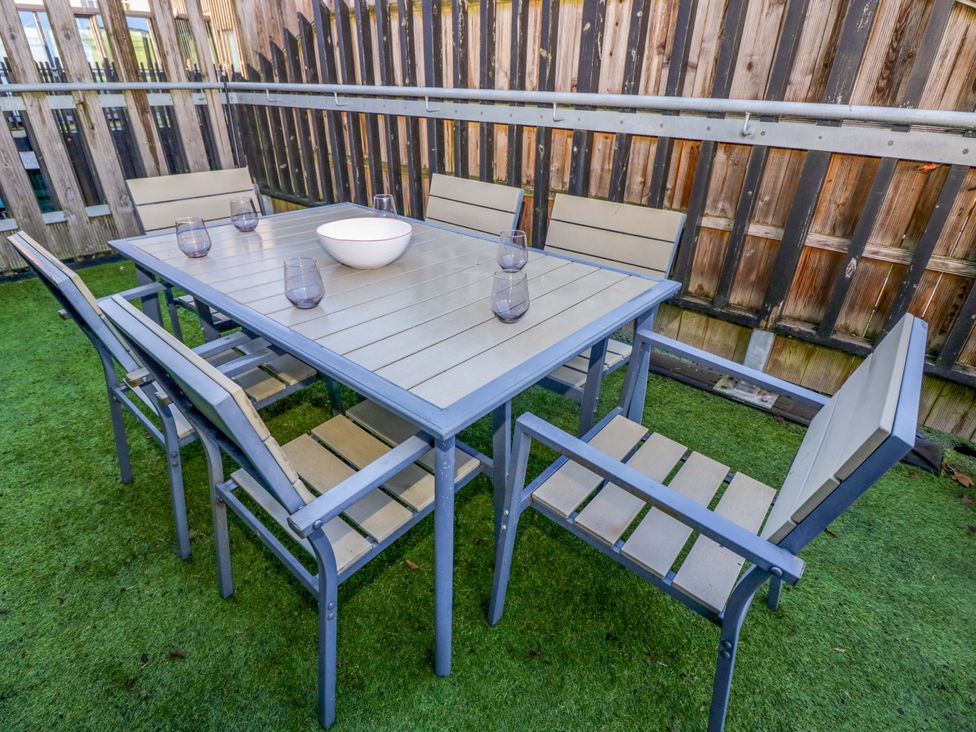 A table with chairs and decorations in an outdoor seating area at 4 The Stoneyard Bath