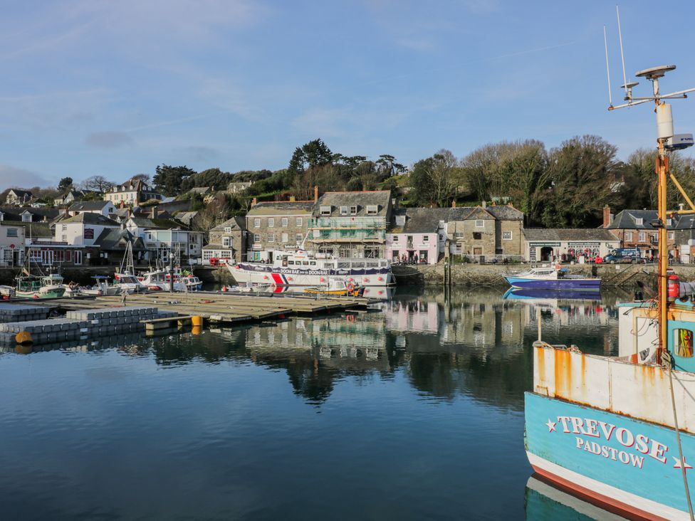 A harbor with boats docked near a quay and buildings along the waterfront at 101 Atlantic Bays Holiday Park in Padstow