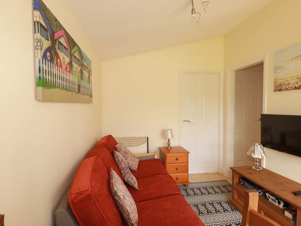 A living room with a sofa and television at 101 Atlantic Bays Holiday Park in Padstow