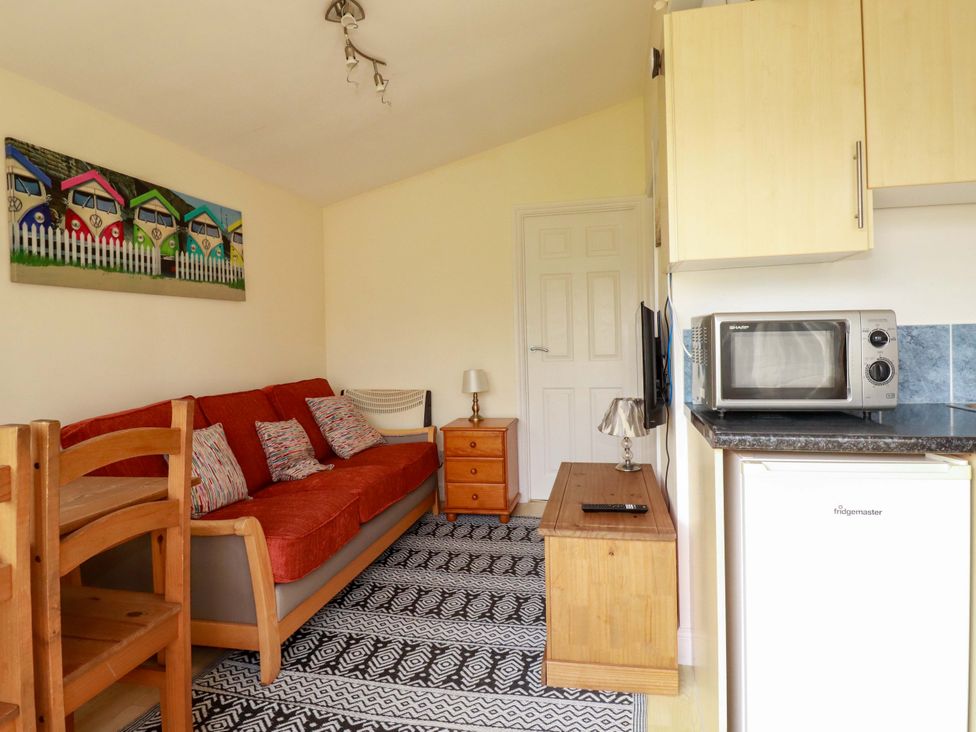 A living room with a sofa and a coffee table at 101 Atlantic Bays Holiday Park in Padstow