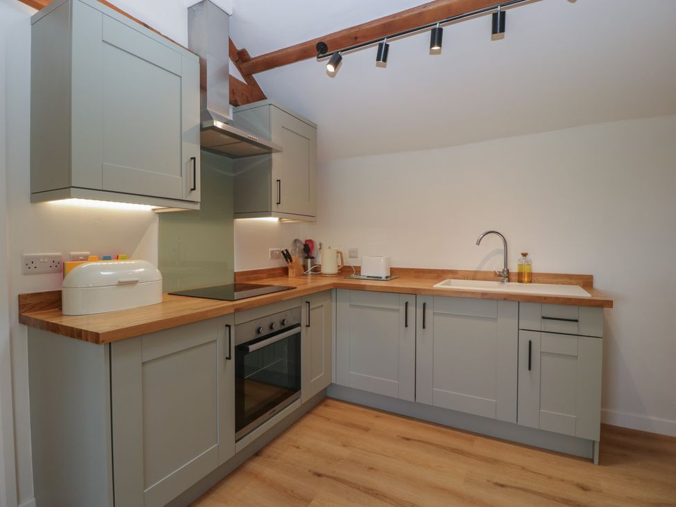 A kitchen with cabinets and appliances at Ynys Pandy near Ewyas Harold