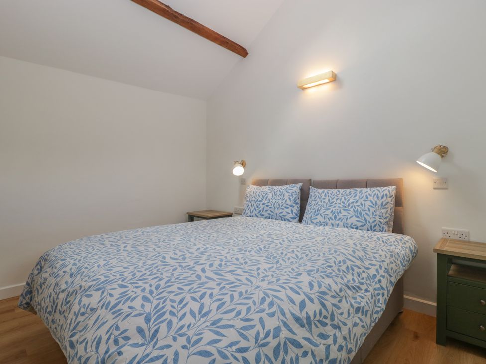 A bedroom with a bed and nightstands at Ynys in Pandy near Ewyas Harold
