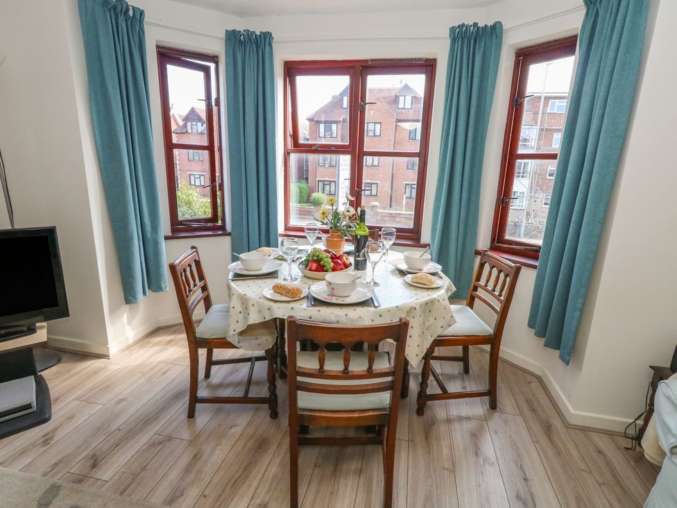 A dining room with a table set for a meal at Flat 9 in Swanage