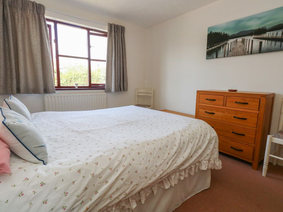 A bedroom with a bed and dresser at Flat 9 in Swanage