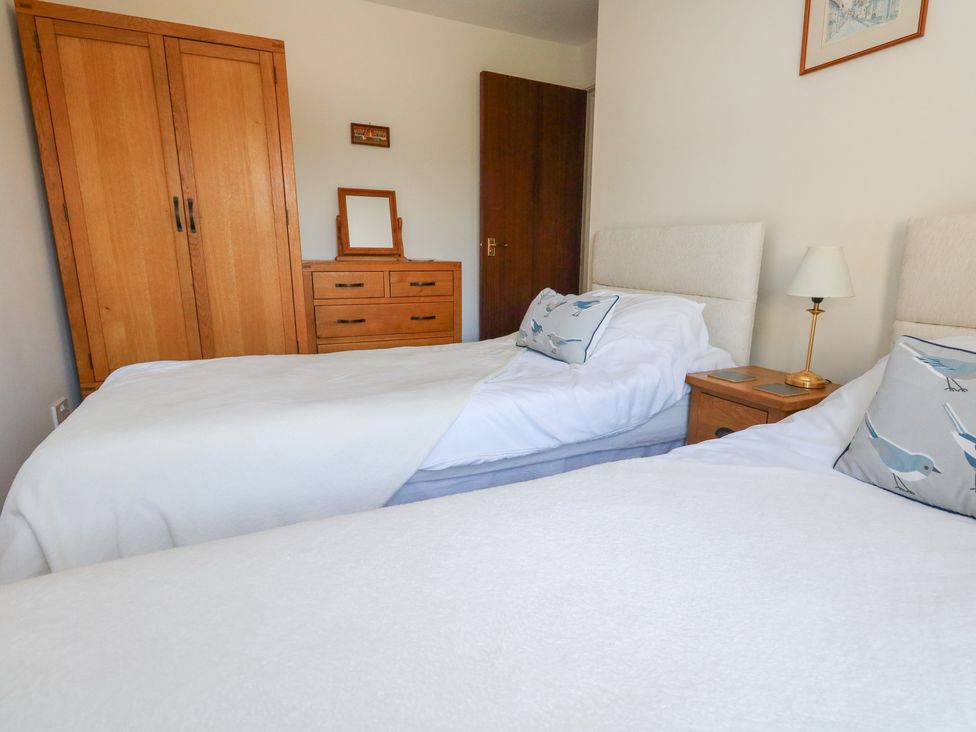 A bedroom with two beds and furniture at Flat 9 in Swanage