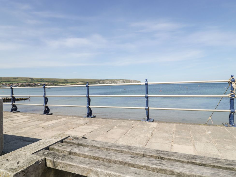 A view of water with boats from a pavement at Flat 9 in Swanage