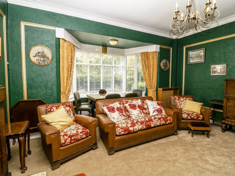 A living room with a sofa and armchair at Bentfield House, Rotherham near Whiston