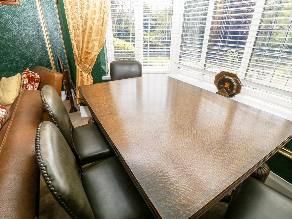 A dining room with a table and chairs at Bentfield House in Rotherham near Whiston