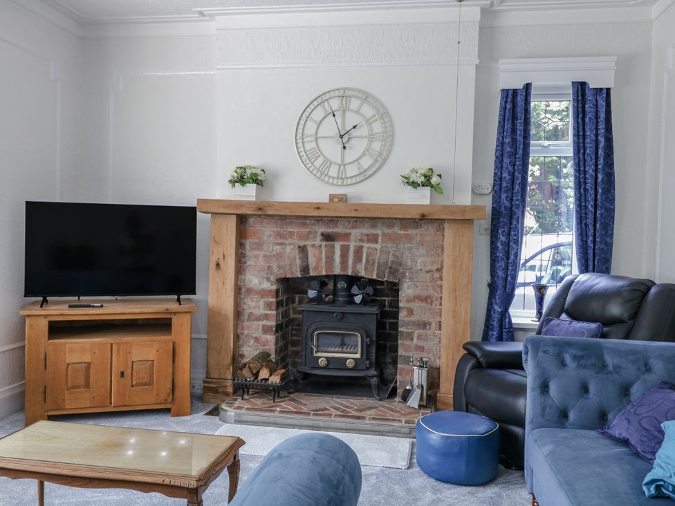 A living room with a television and a fireplace at Bentfield House in Rotherham near Whiston