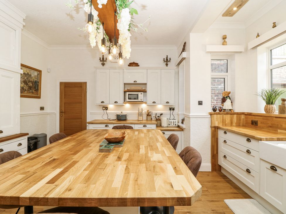 A kitchen with a wooden table and chairs at Bentfield House near Rotherham
