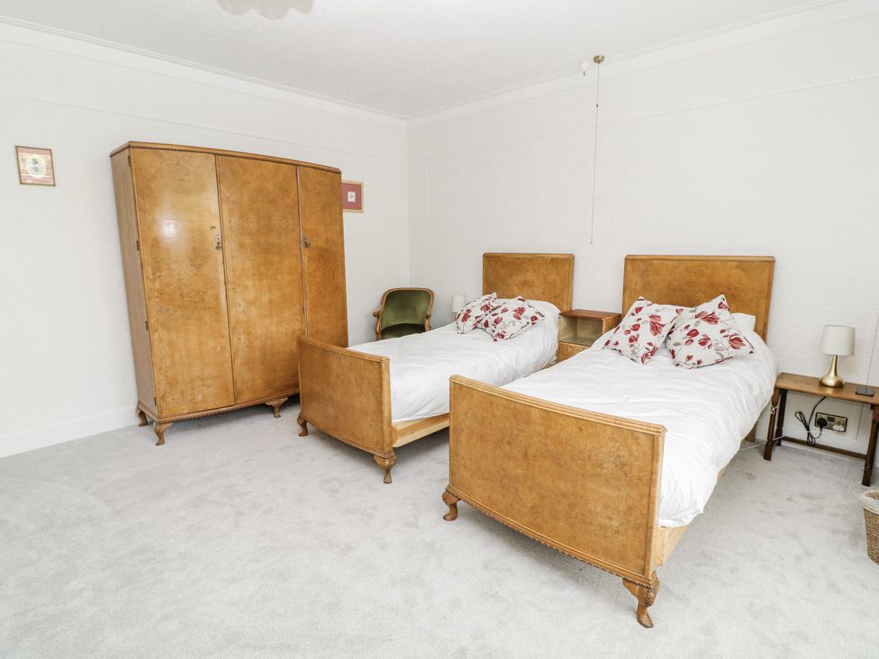 A bedroom with two beds and a wardrobe at Bentfield House in Rotherham near Whiston