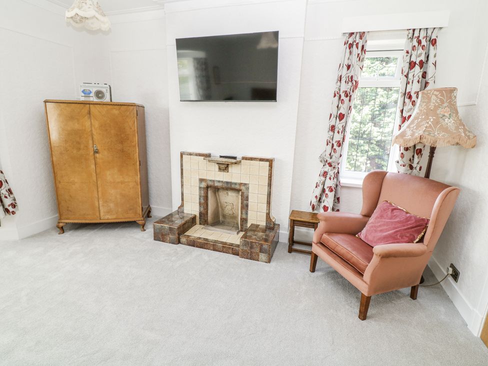 A living room with a television and an armchair at Bentfield House, Rotherham near Whiston