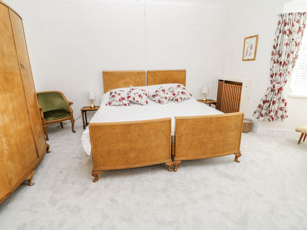 A bedroom with a bed and armchair at Bentfield House in Rotherham near Whiston
