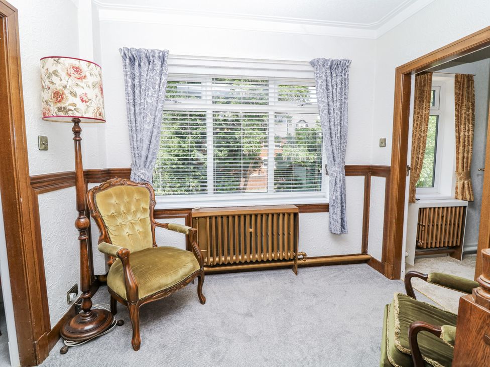 A living room with a window, chair, and lamp at Bentfield House in Rotherham near Whiston