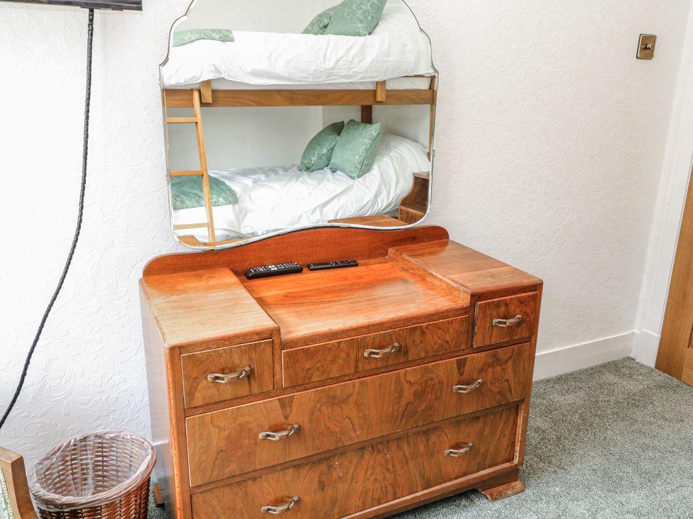 A bedroom with a dresser and a bunk bed at Bentfield House Rotherham near Whiston