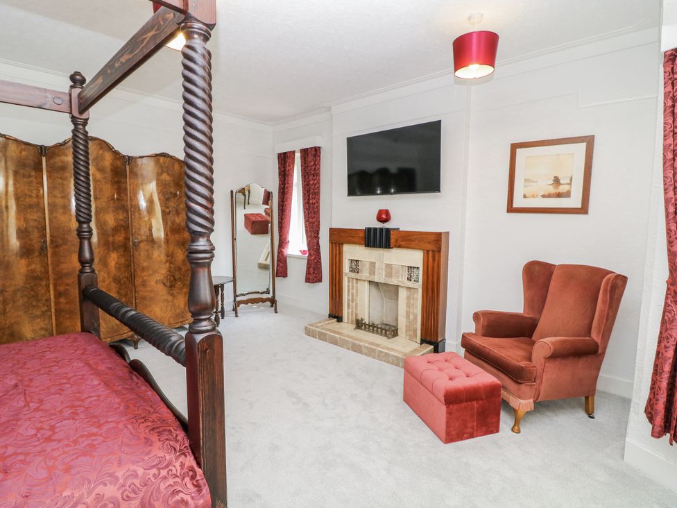 A bedroom with a fireplace and a television at Bentfield House in Rotherham near Whiston