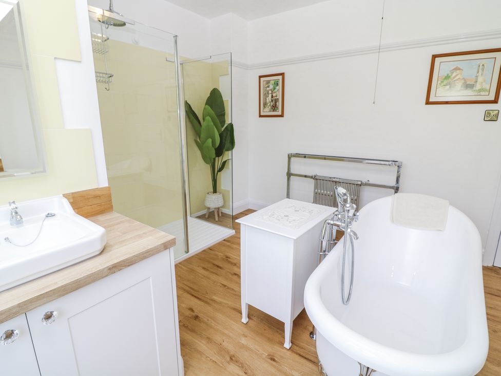 A bathroom with a bathtub and shower at Bentfield House Rotherham near Whiston