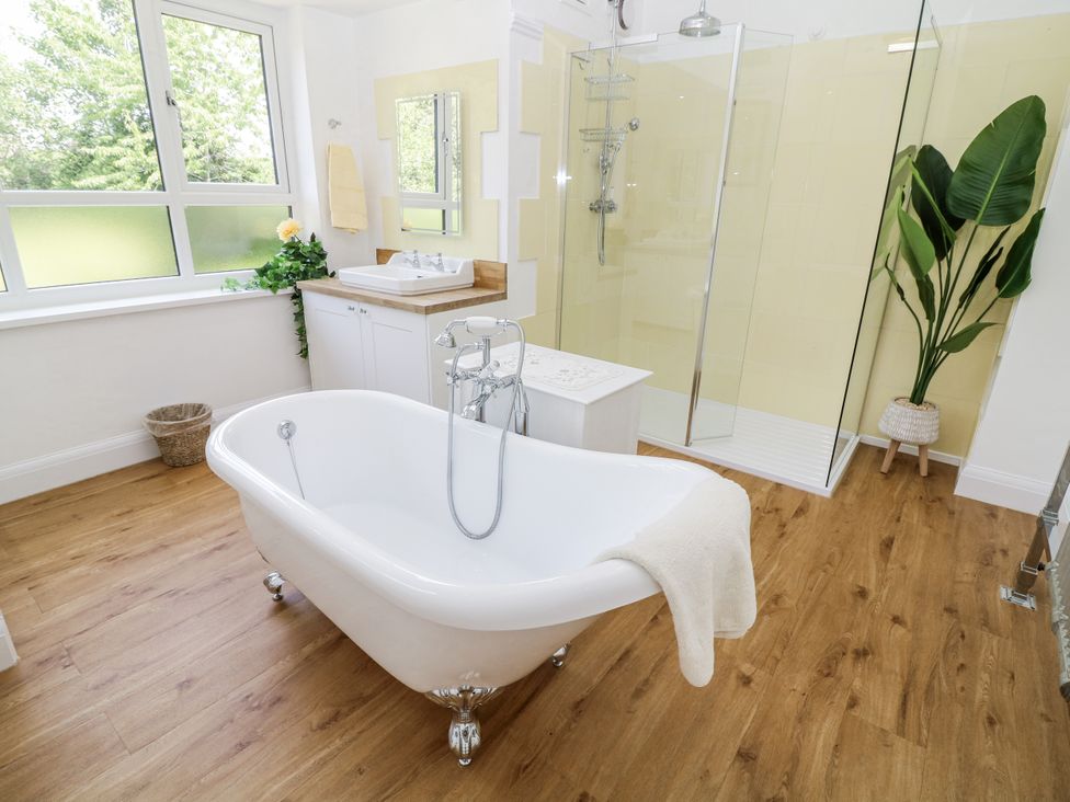 A bathroom with a bath tub and shower at Bentfield House in Rotherham near Whiston