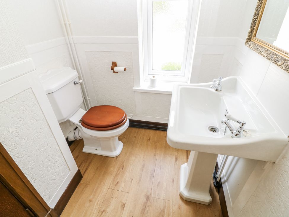 A bathroom with a toilet and sink at Bentfield House in Rotherham near Whiston