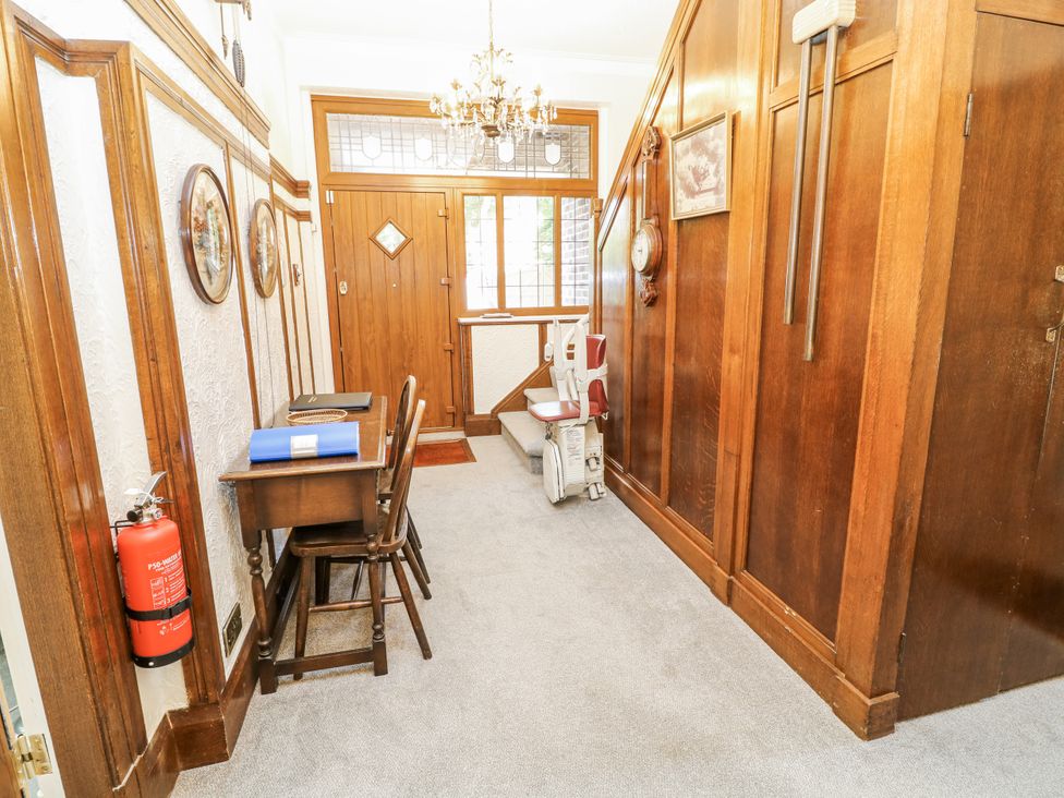 A hallway with a chair and table at Bentfield House, Rotherham near Whiston