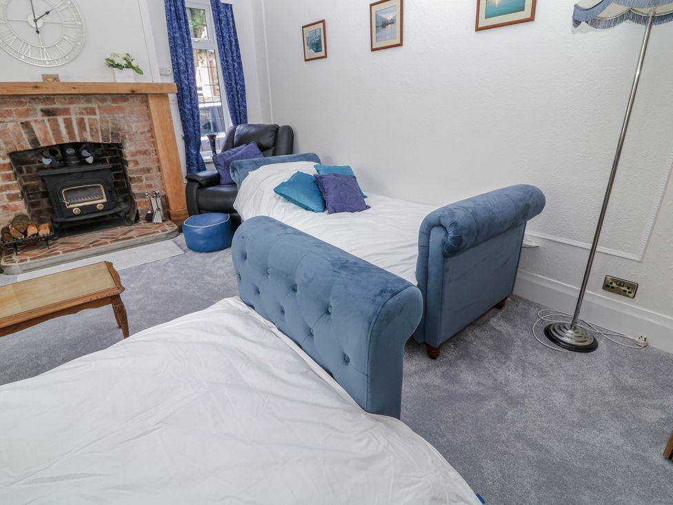 A living room with a fireplace and a sofa at Bentfield House in Rotherham near Whiston