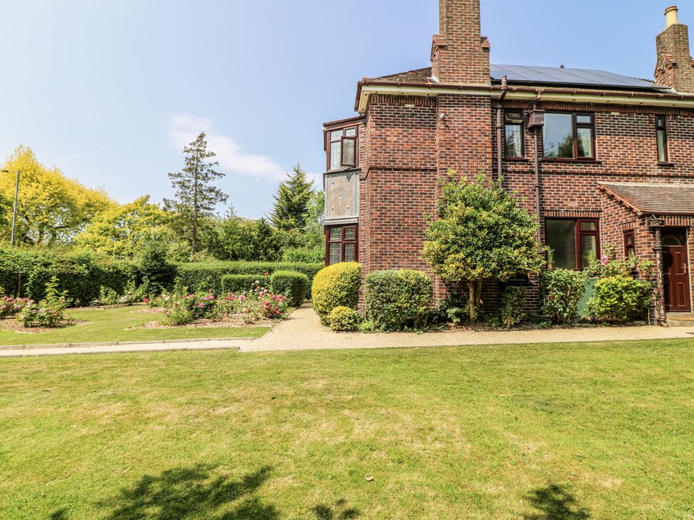 An exterior view of a brick house with a garden at Bentfield House in Rotherham near Whiston