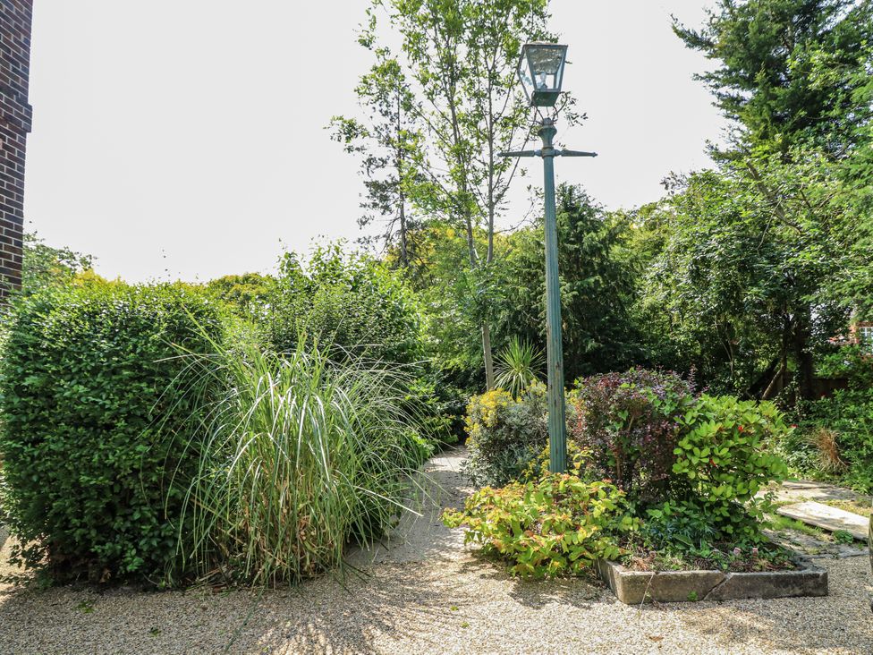 A garden with bushes and a lamp post at Bentfield House Rotherham near Whiston