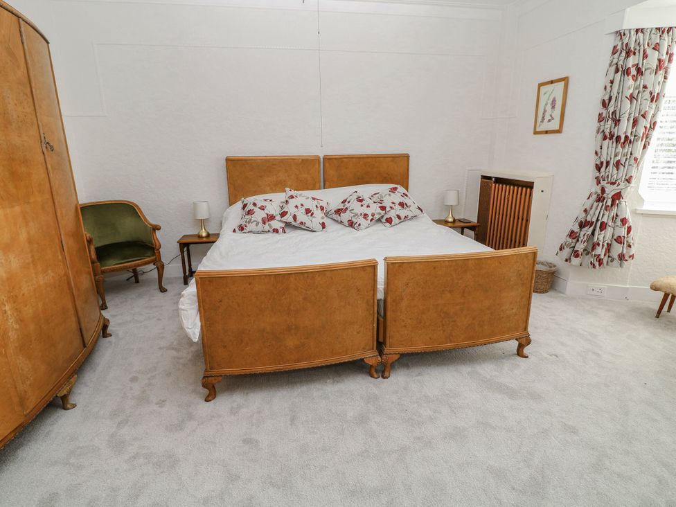 A bedroom with a bed and an armchair at Bentfield House in Rotherham near Whiston