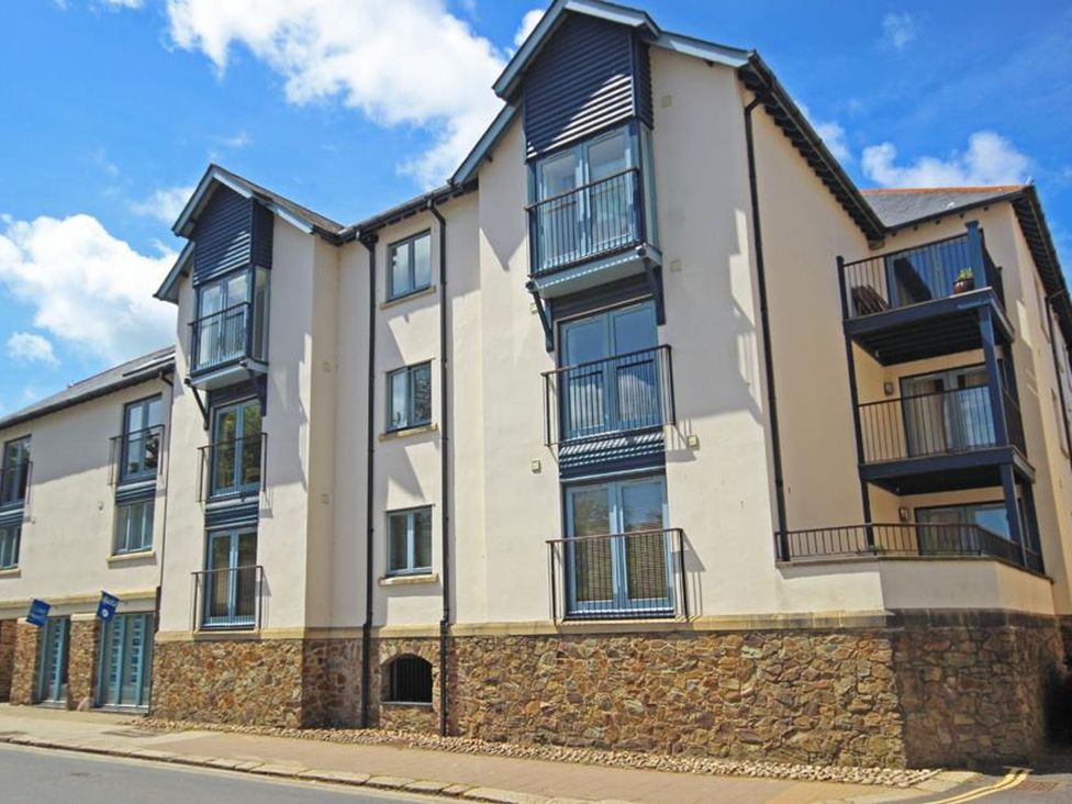 A multi-story residential building with stone base and balconies at 10 Dartmouth House in Dartmouth