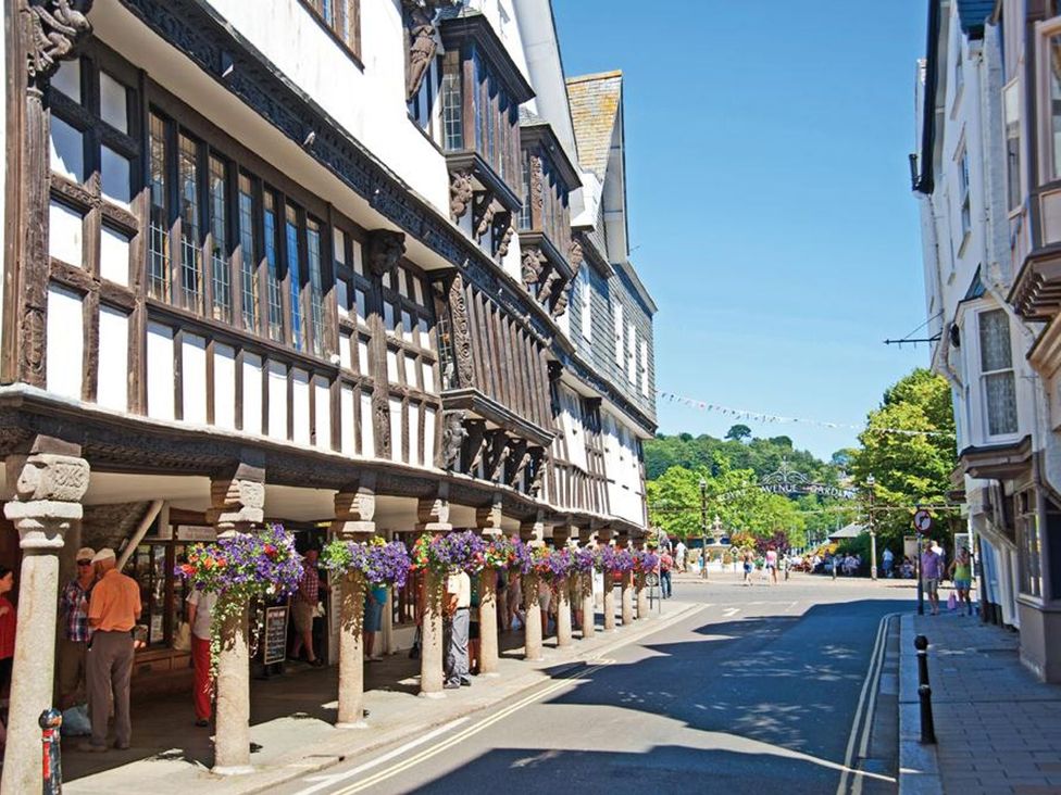 A street with timber framed buildings and hanging flower baskets at 10 Dartmouth House in Dartmouth