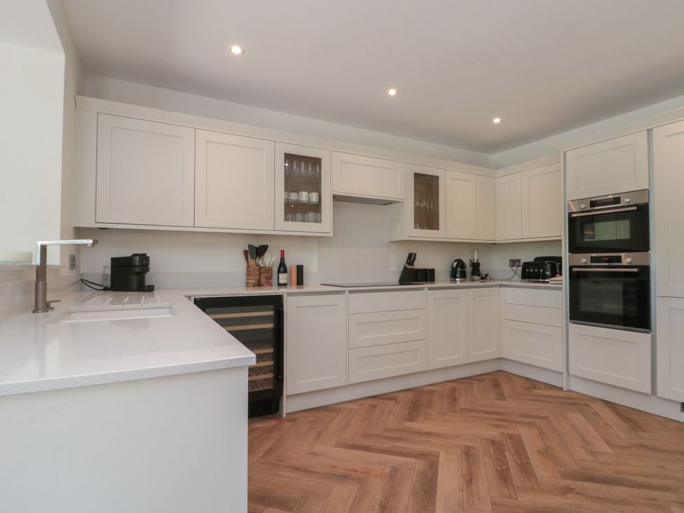 A kitchen with cabinets and appliances at 12 Gap Road in Filey