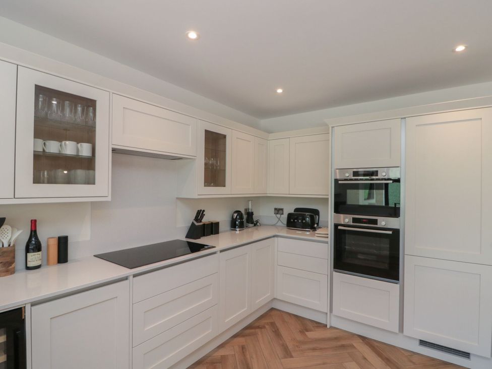 A kitchen with cabinets and appliances at 12 Gap Road, Filey