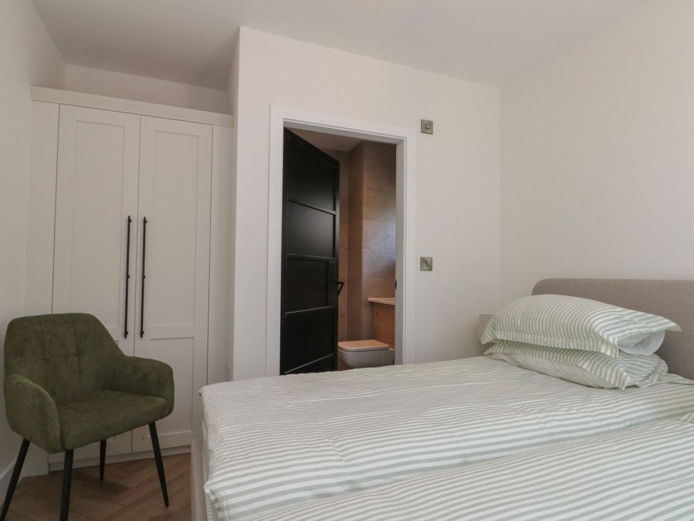 A bedroom with a bed and wardrobe at 12 Gap Road, Filey