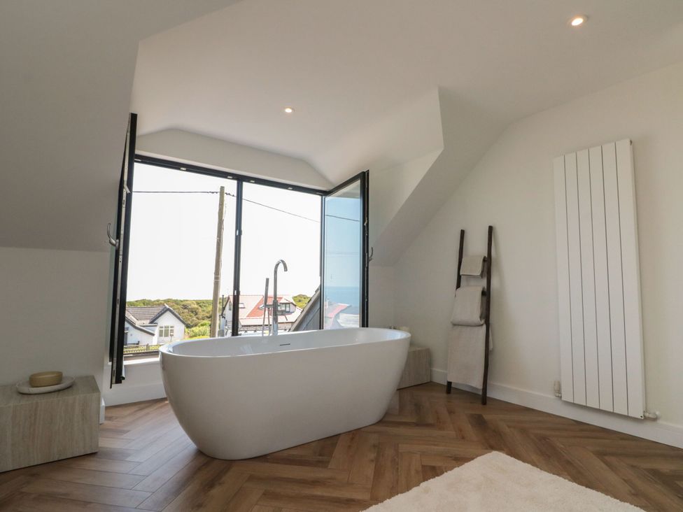 A bathroom featuring a bathtub and a window at 12 Gap Road in Filey