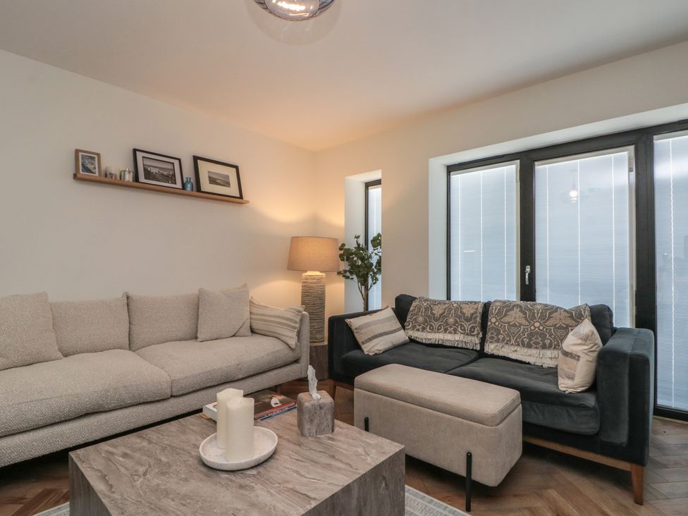 A living room with sofas and a coffee table at Puffin Lodge in Hunmanby