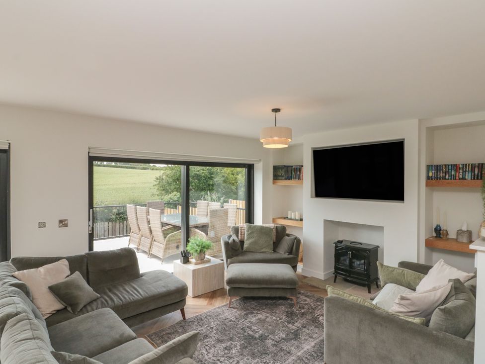 A living room with a sofa and television at Puffin Lodge in Hunmanby