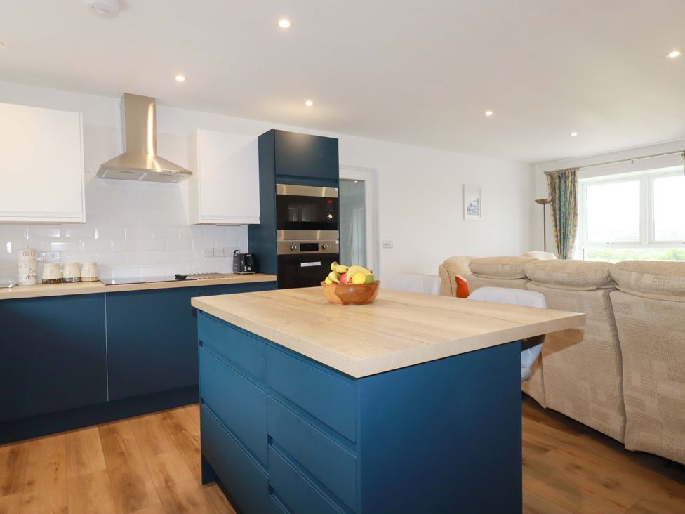 A kitchen with an island counter and appliances at Folly View in Cambrose near Illogan
