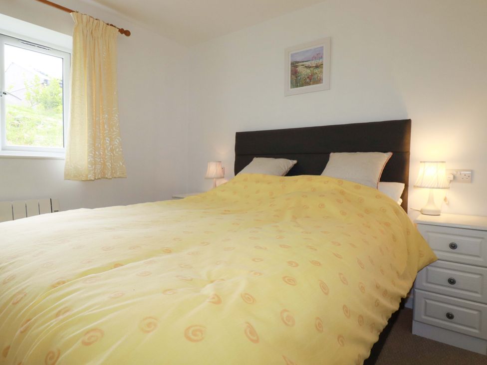 A bedroom with a bed and lamps at Folly View in Cambrose near Illogan