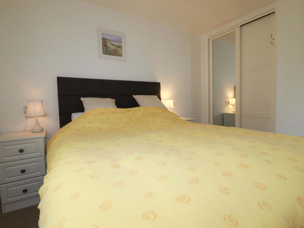 A bedroom with a bed and bedside tables at Folly View Cambrose near Illogan